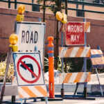 A collection of roadwork signs, reading Road closed, wrong way, do not turn left.